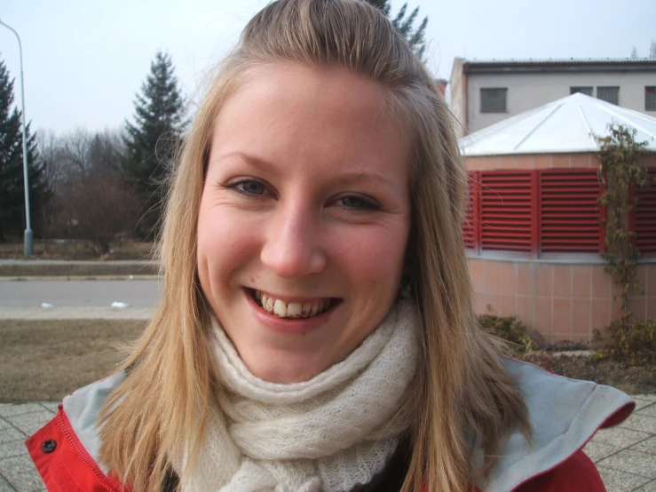 a lady with long blonde hair smiling at the camera