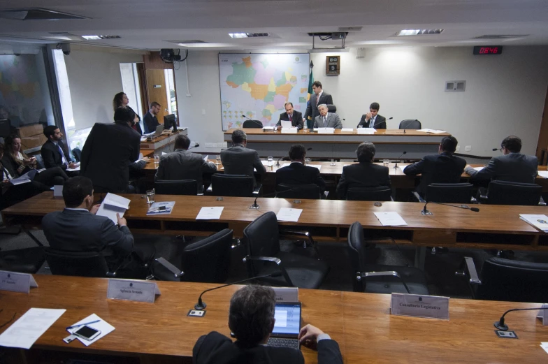 an office has people on the tables with laptops