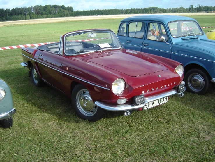 two old style cars at a car show