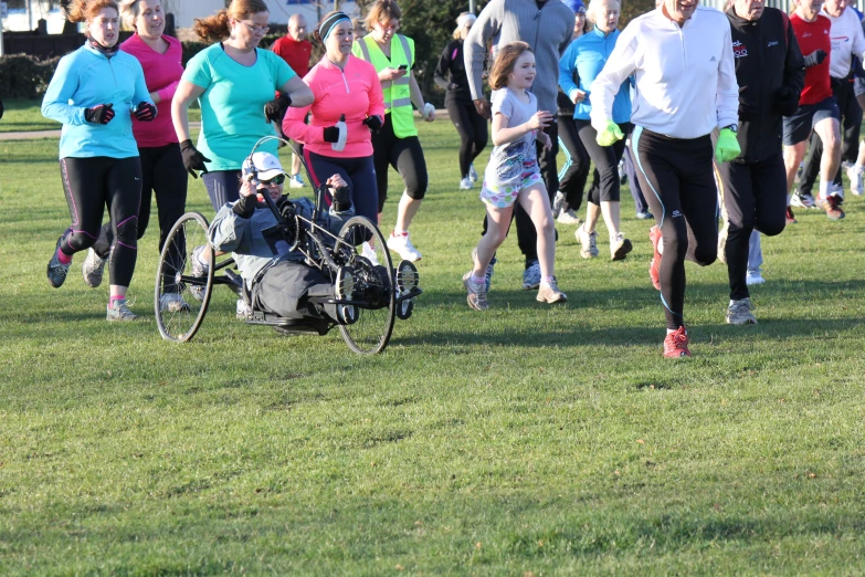 a man hing a wheelchair on top of a field