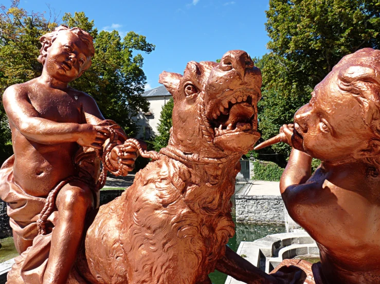 two statues sitting together while one holds up a cane