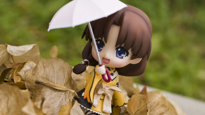 a close up of a plastic figurine with an umbrella