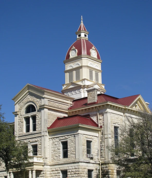 a large white building with a red and white roof