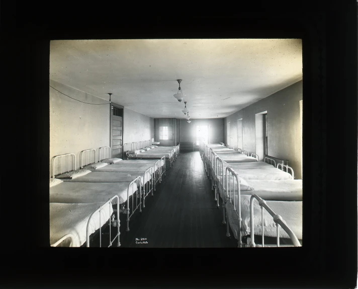 a long line of tables with white blankets on them