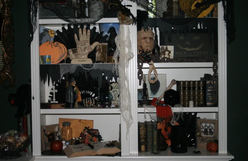 halloween bookshelves are decorated with lots of pumpkins and black spooks