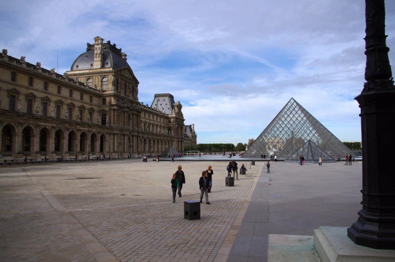 a po of people walking in front of a pyramid