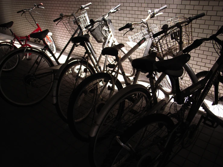 the bikes are lined up against the wall