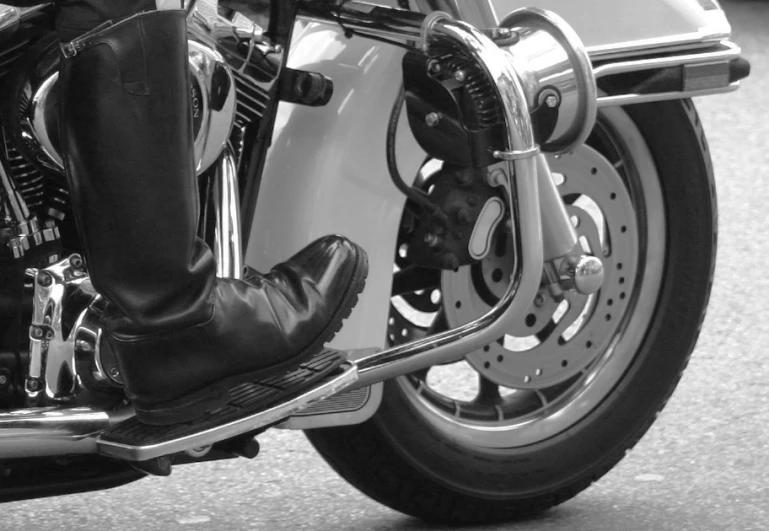 the feet of a man on a motorcycle