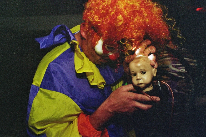 a man wearing clown wigs and holding a little boy
