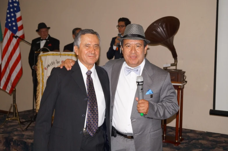 two men in suits and ties pose for a picture