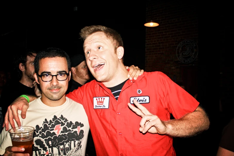 two people are laughing at the camera while posing for the camera