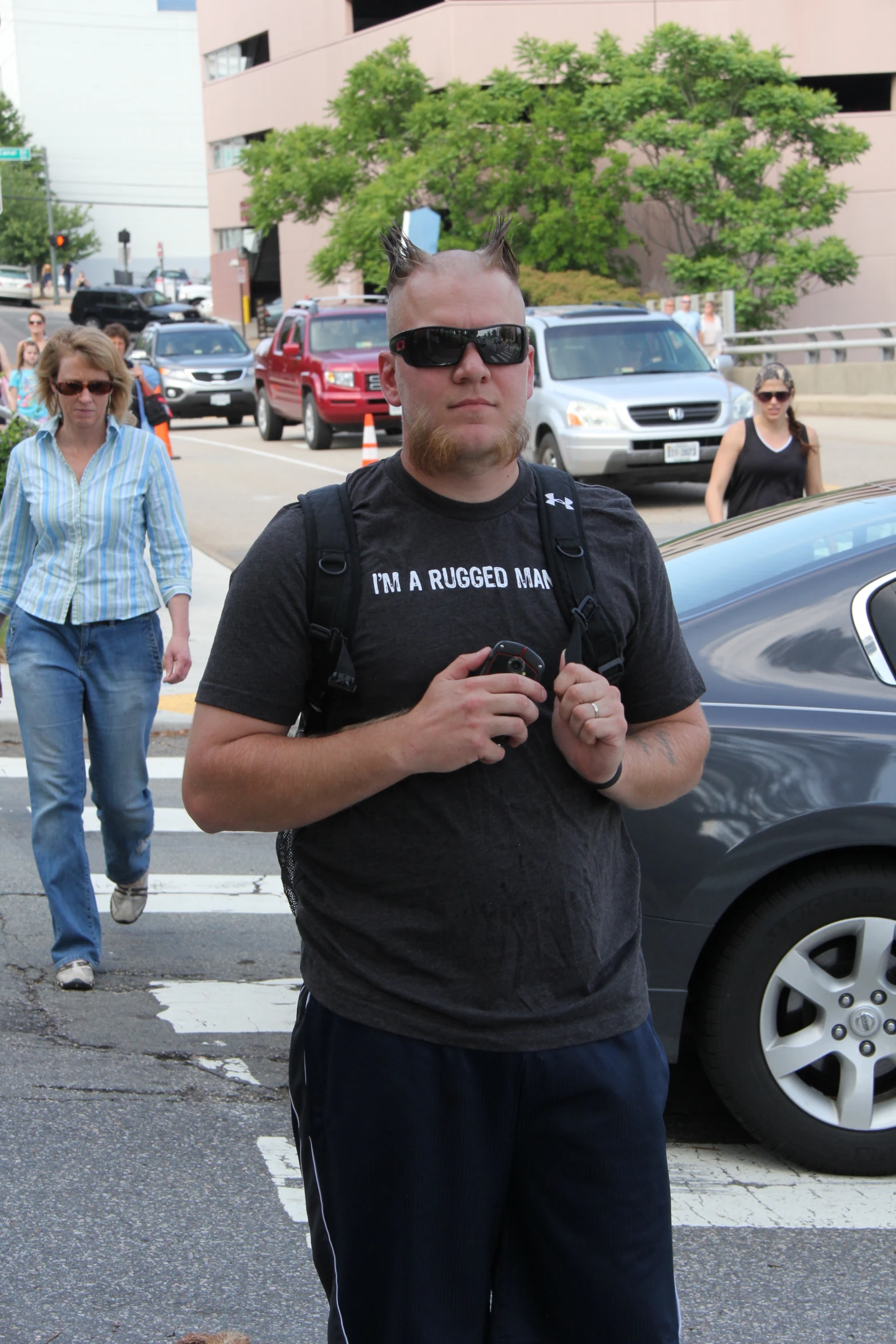 a man standing in a street holding a camera