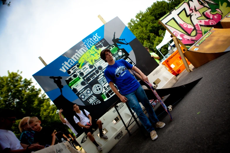 a man stands in front of a sign while people walk