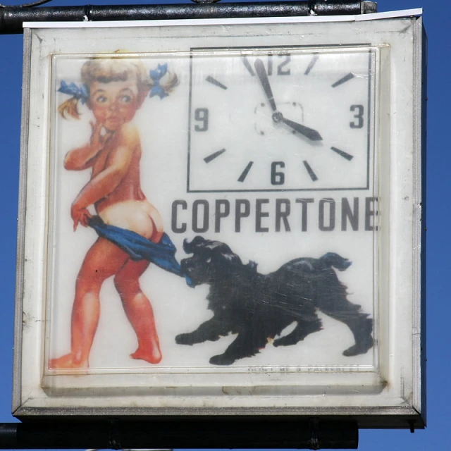 a sign with an ad for coppertone for women