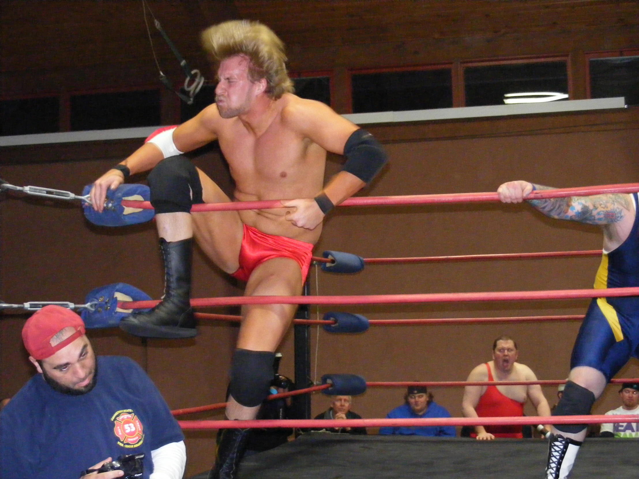 two wrestlers sitting next to each other in a ring