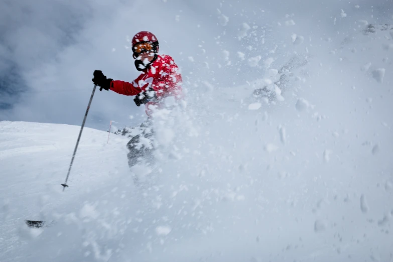 a skier has just caught a big spray of snow