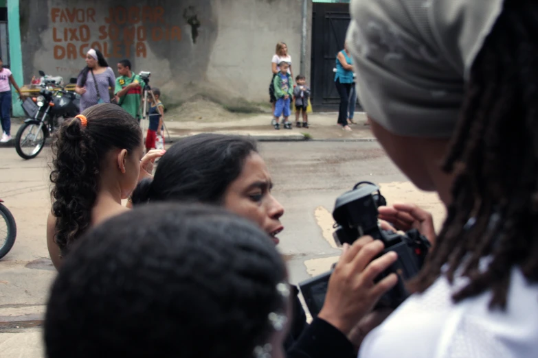 a young woman holding a camera and taking pictures