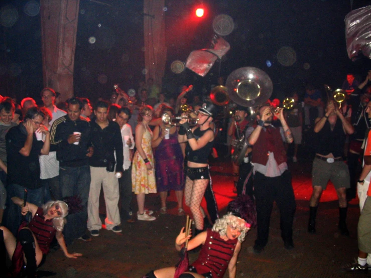 a woman dressed in lingerie at party with a band