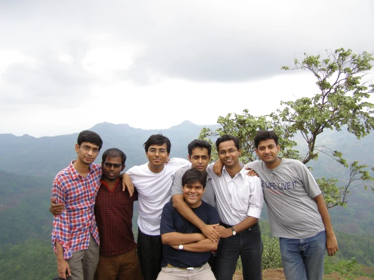 group of young men posing with a mountain view in the background