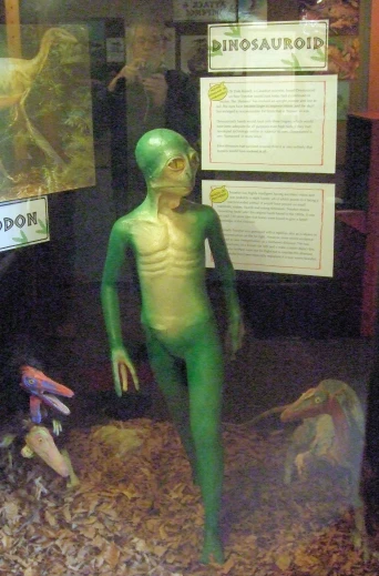 an alien like costume is on display in a window