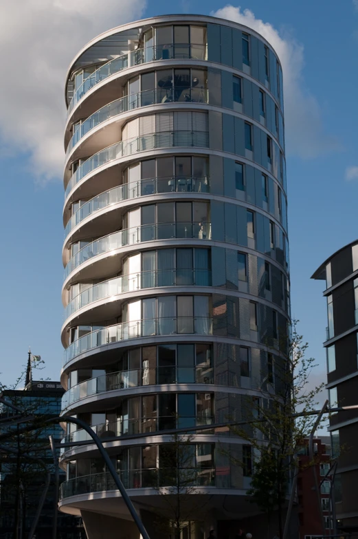 a building with windows against a blue sky and clouds