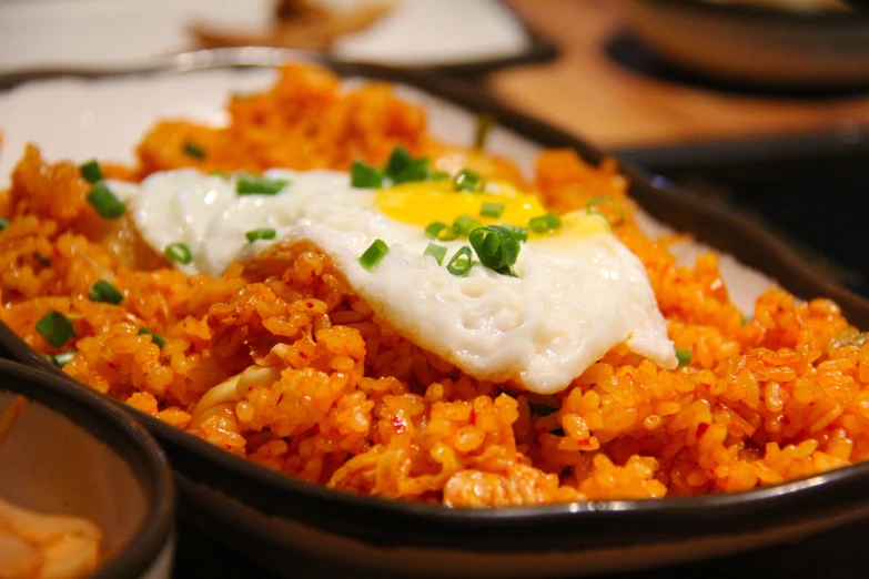 a large bowl filled with meat and rice