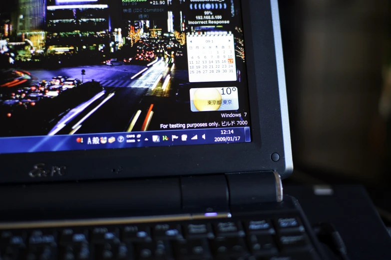 an open laptop computer with an image of a city