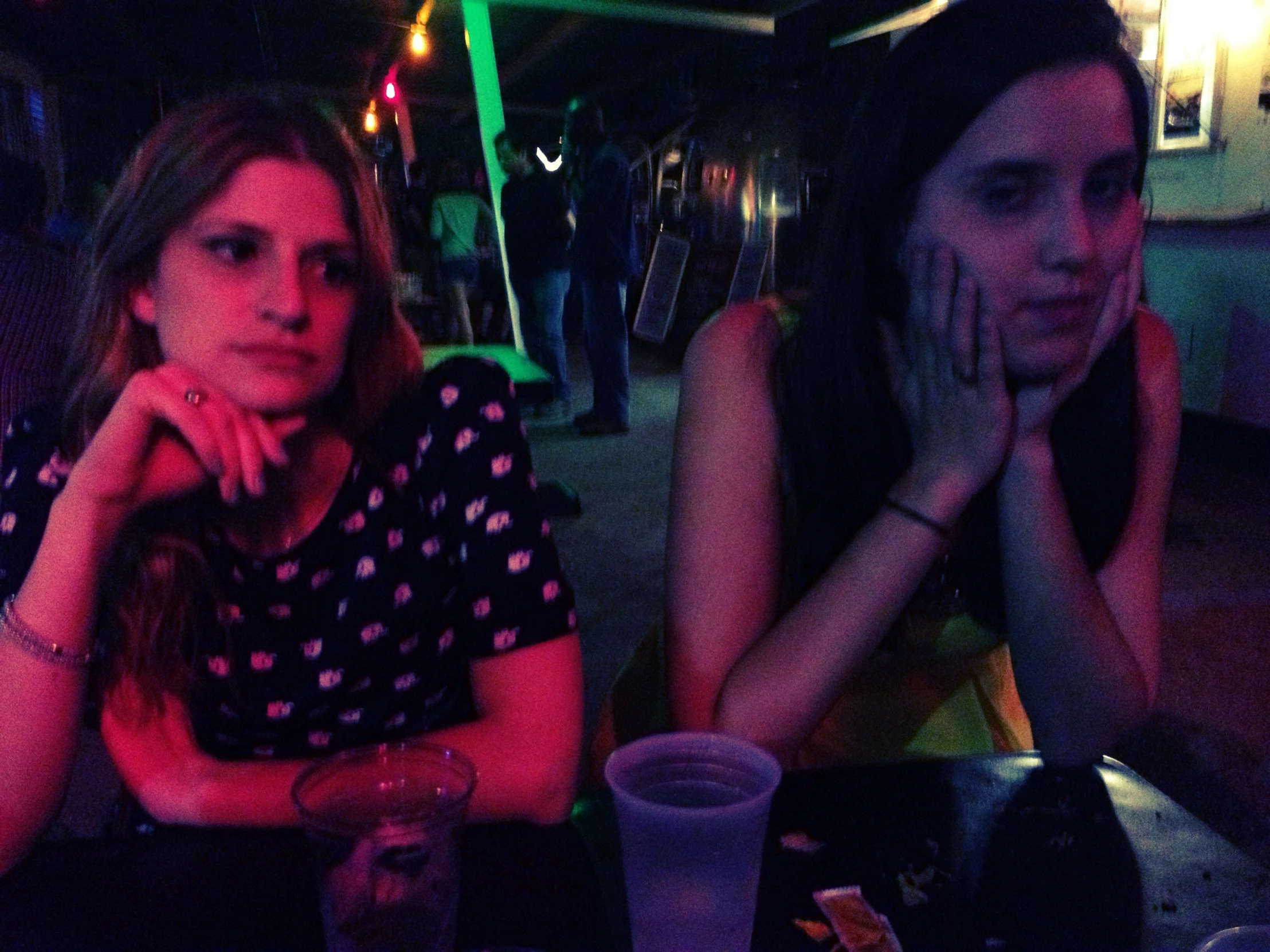 two women at a table with drinks in front of them