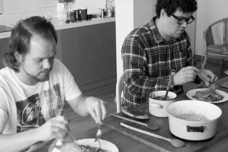 two people at a table with food in bowls