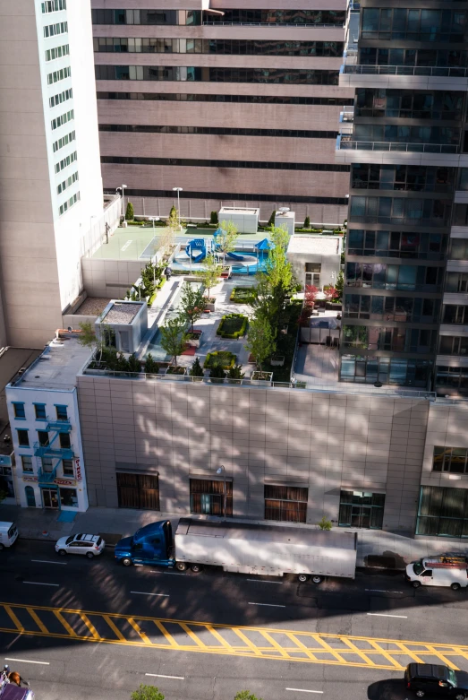 an empty parking lot sits next to an apartment building