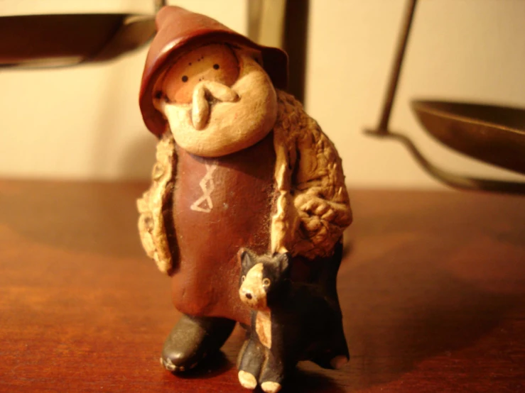 a little ceramic gnome with an animal toy