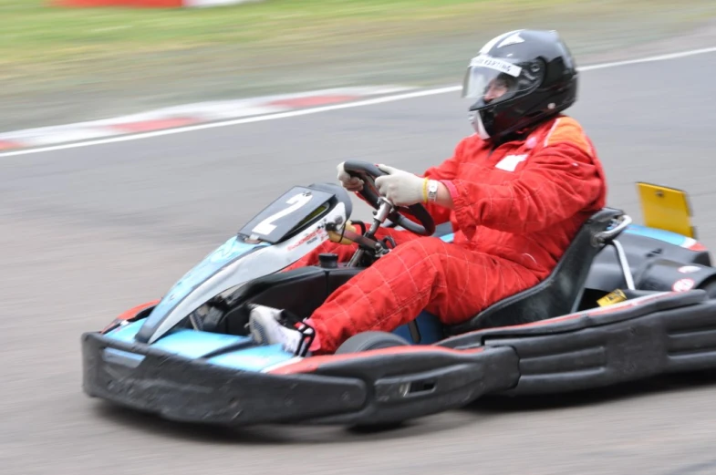a man in a racing car drives down the track