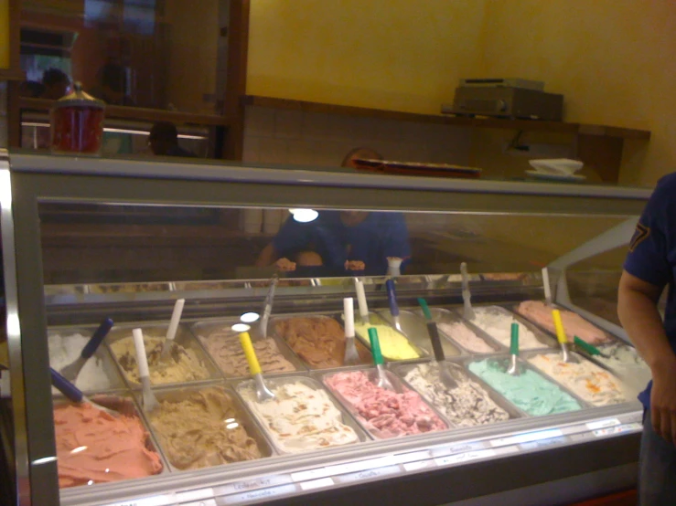 a large display case with many different scoops of ice cream