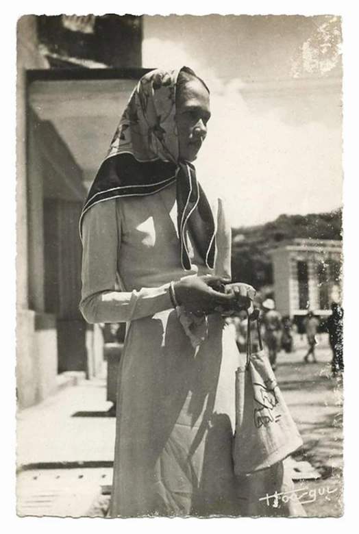 a black and white image of a lady wearing a head scarf