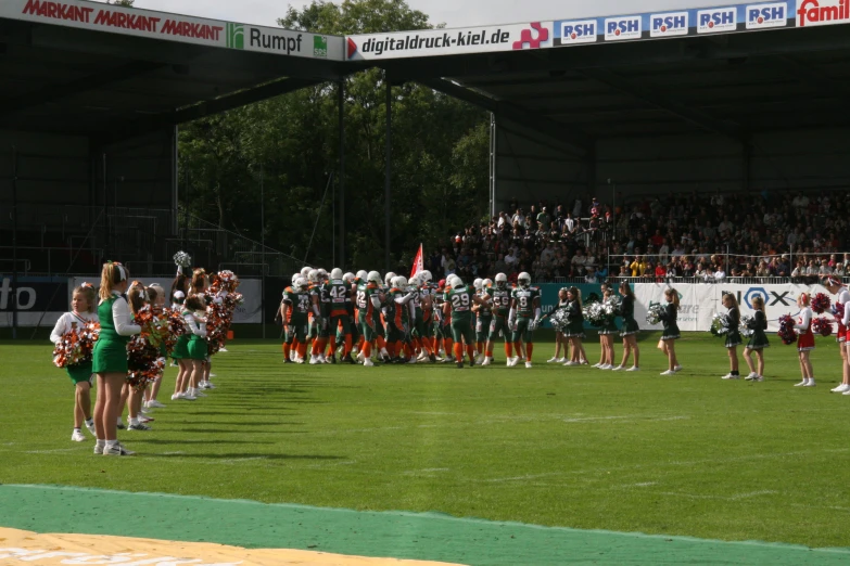 a group of cheerleaders lined up and waiting for the teams to take their place