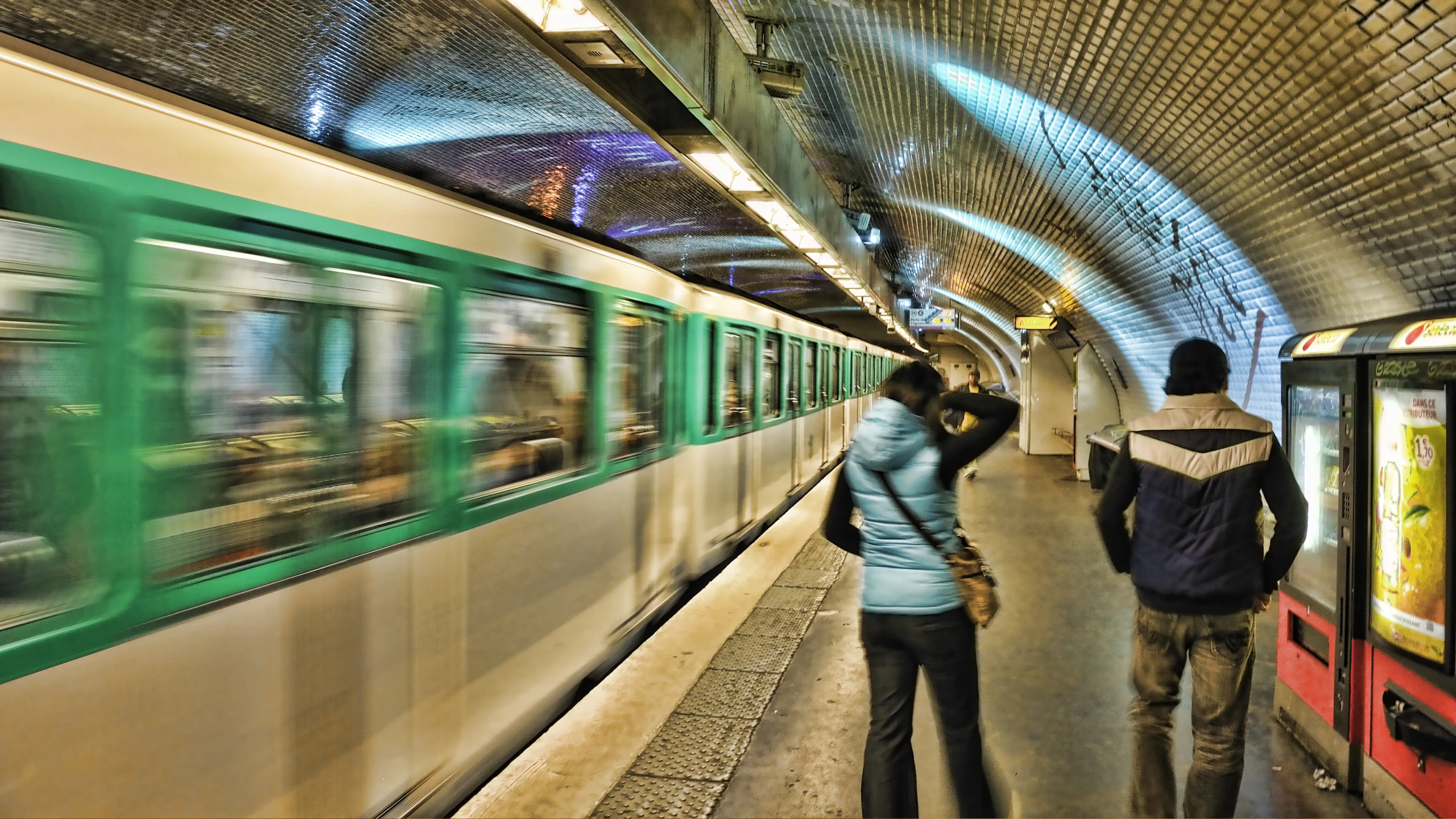 people standing by a train at the train station