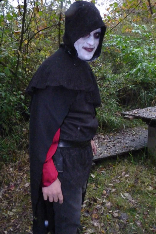 a person in a black costume with his face painted