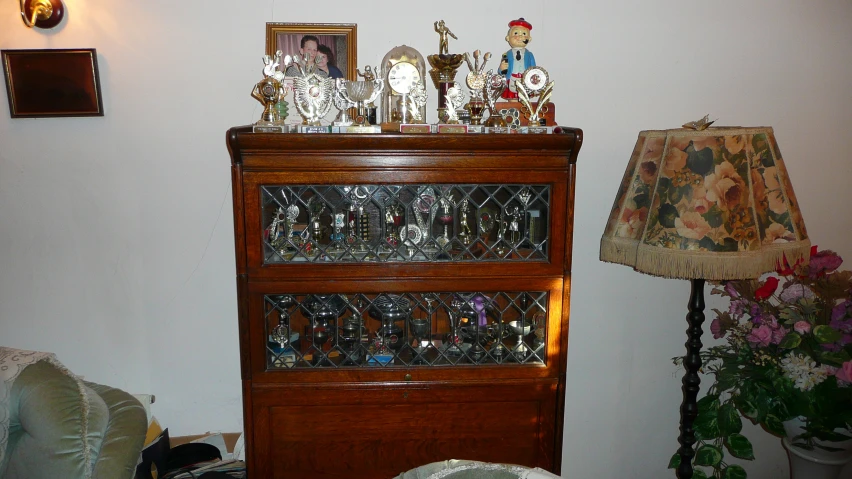 an empty china cabinet is filled with some items