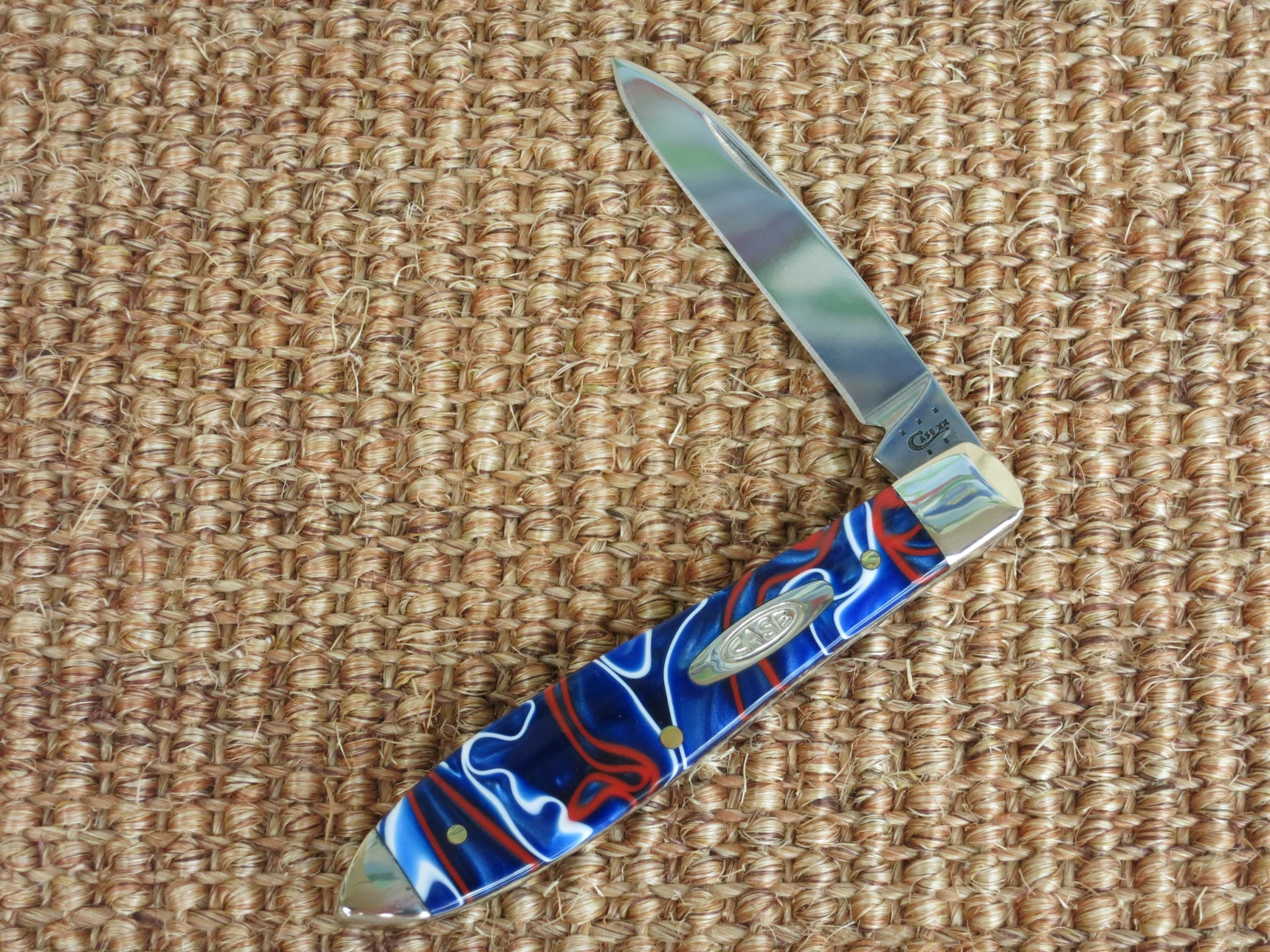 an orange red blue and white hand - made knife