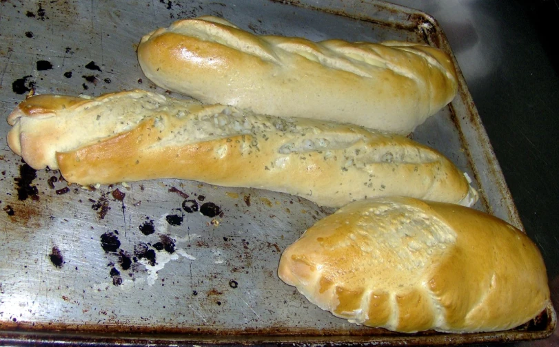 some type of baked bread sitting on a pan
