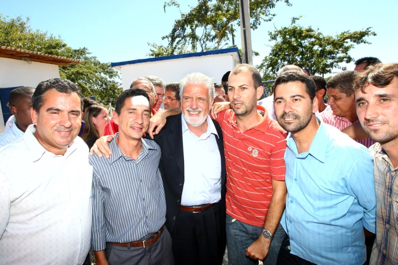 several men standing next to each other in front of a crowd