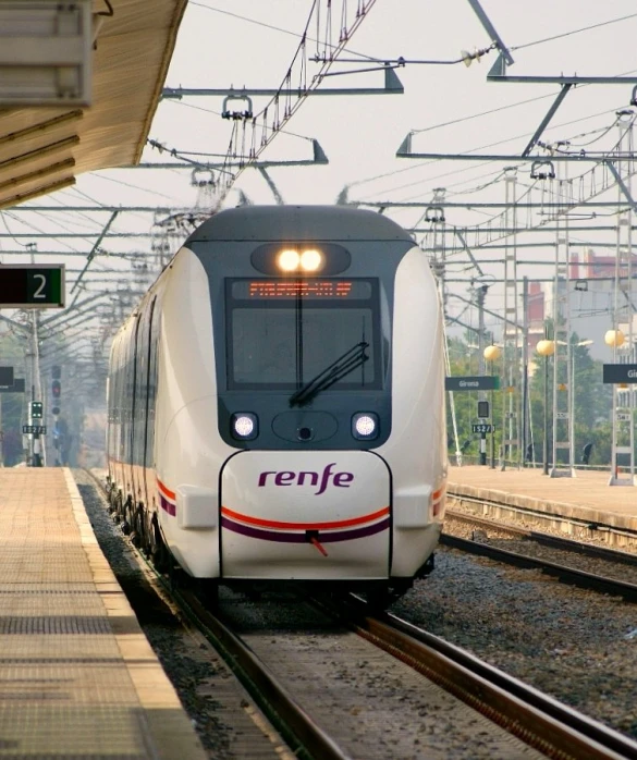 a commuter train is at a train stop