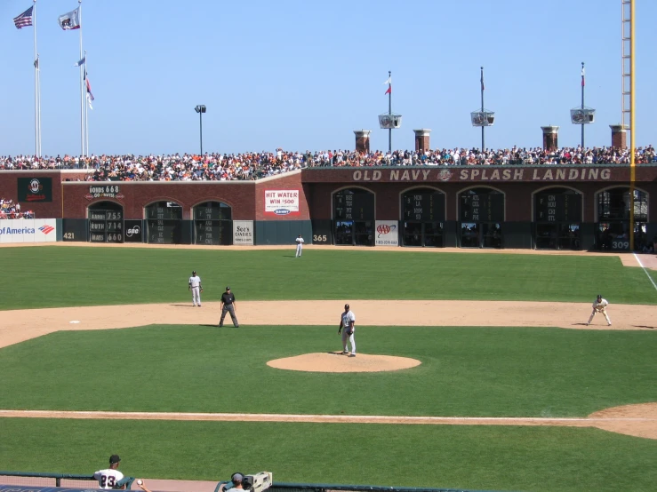 a group of baseball players standing on top of a field