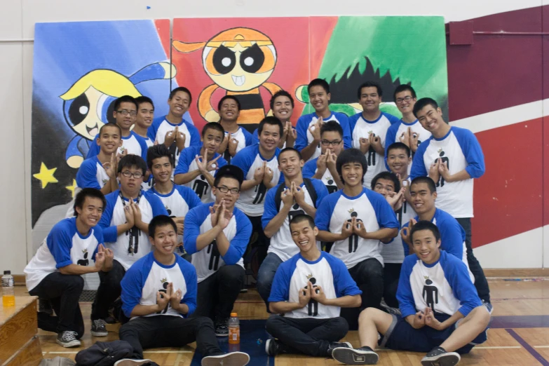 a group of people posing for the camera on a basketball court