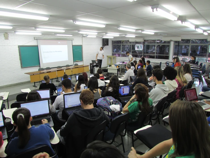 a classroom full of students with their laptops