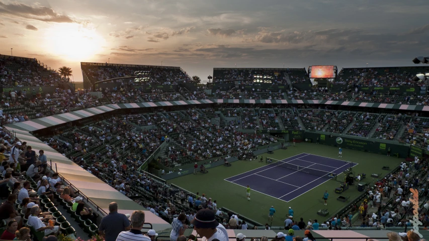a tennis match in a dark stadium