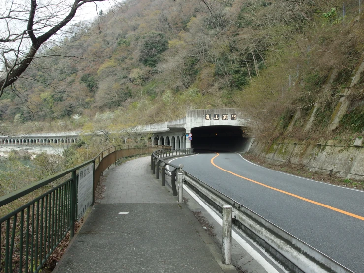 a road with an exit way going under a tunnel