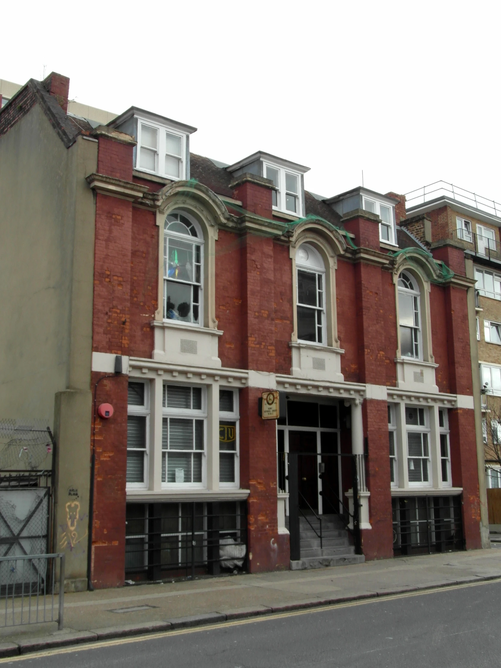 a very old brick building on the side of the street