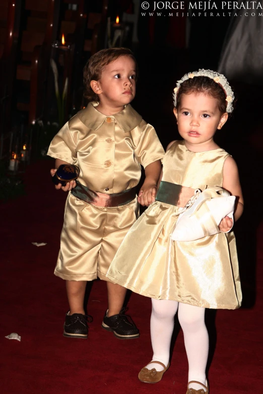 two children in fancy dress standing side by side