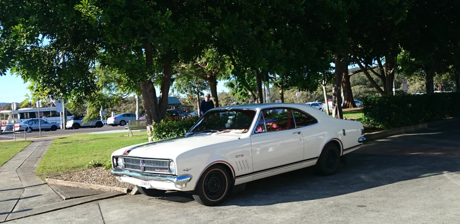 an old car is parked in a driveway